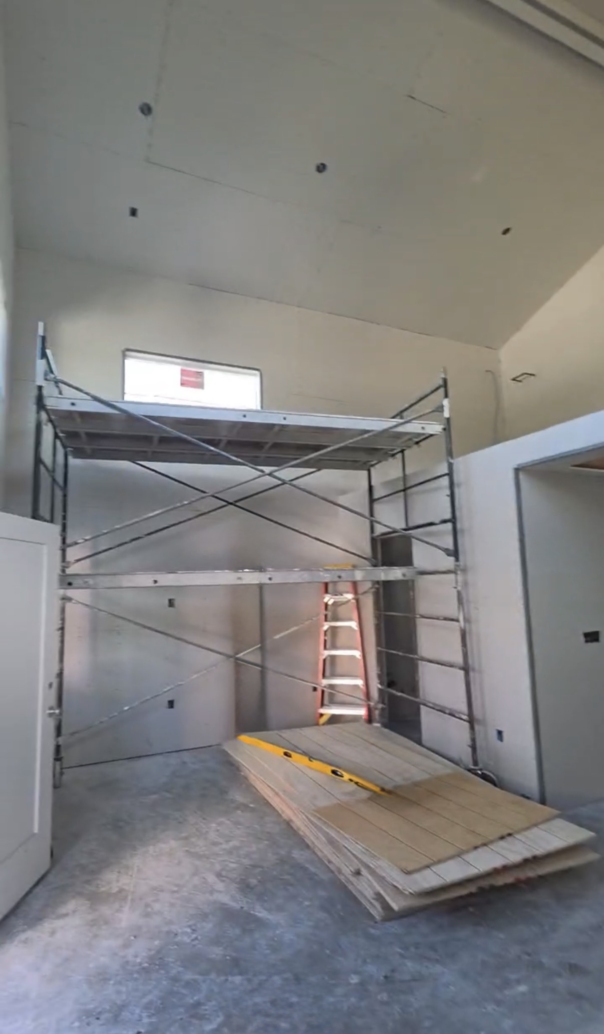 Tall vaulted room during drywall finishing